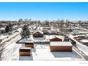 Aerial view of a house and surrounding neighborhood in winter at 245 Cedar St, Hudson, CO 80642