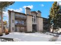 Front view of a condo building with stone exterior and balconies at 2575 S Syracuse Way # E-302, Denver, CO 80231