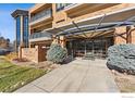 Condo building entrance with covered walkway and landscaping at 2801 Pennsylvania Ave # 201, Boulder, CO 80303