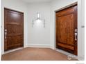 Interior hallway with two wood doors and carpet flooring at 2801 Pennsylvania Ave # 201, Boulder, CO 80303