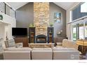 Living room featuring a floor-to-ceiling stone fireplace and ample seating at 313 S 3Rd Ave, Superior, CO 80027