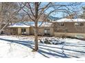 Home's back exterior features a deck and snowy yard at 350 Hopi Pl, Boulder, CO 80303