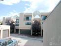 Tan multi-unit building with arched entryways and attached garages at 3805 Northbrook Dr # A, Boulder, CO 80304