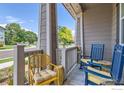 Front porch with blue and yellow chairs, inviting and relaxing at 462 Canadian Crossing Dr, Longmont, CO 80504