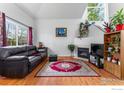 Cozy living room featuring a fireplace and hardwood floors at 51 21St Ave # 30, Longmont, CO 80501