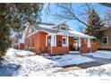 Charming brick home with a covered porch and snowy yard at 624 Maxwell Ave, Boulder, CO 80304