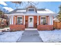 Attractive brick home with a white door and snowy front yard at 624 Maxwell Ave, Boulder, CO 80304