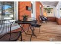 Cozy front porch with black metal table and chairs at 624 Maxwell Ave, Boulder, CO 80304