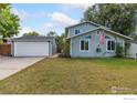 House exterior showcasing a two-car garage and neat landscaping at 927 Quartz Ct, Longmont, CO 80504