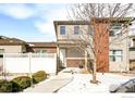 Townhouse exterior with snowy front yard and walkway at 11278 Colony Cir, Broomfield, CO 80021