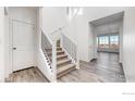 Modern staircase with black metal railing and carpeted steps at 12915 E 102Nd Pl, Commerce City, CO 80022