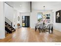 Bright dining area featuring modern lighting, table setting for six, and beautiful hardwood floors at 2125 Vine Ave, Boulder, CO 80304
