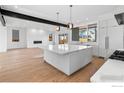 Open concept kitchen with island, stainless steel appliances, and hardwood floors at 2125 Vine Ave, Boulder, CO 80304