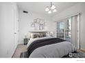 Virtually staged bedroom with balcony access at 3000 Blue Sky Cir # 108, Erie, CO 80516