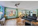 Mid century modern living room with leather couch and wood floors at 315 Michigan Ave, Berthoud, CO 80513