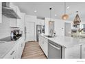Open kitchen with white cabinets, stainless steel appliances, large island, and adjacent dining area at 3178 Beaumont Blvd, Mead, CO 80542