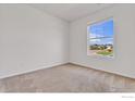 Well-lit bedroom with neutral carpeting and large window at 6508 Copper Dr, Frederick, CO 80516