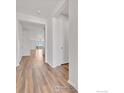 Bright hallway with light wood flooring leads to the living areas at 6508 Copper Dr, Frederick, CO 80516