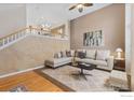 Living room with L-shaped sofa, large windows, and a neutral color palette at 815 Snowberry St, Longmont, CO 80503