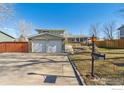 Two-story home with a two-car garage, driveway, and a manicured lawn that enhances its curb appeal at 10596 Ura Ln, Northglenn, CO 80234