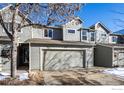 Two-story townhome with attached garage and snow-covered landscaping at 11277 Holly St, Thornton, CO 80233