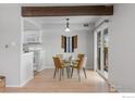 Bright dining area featuring a glass table and a view to the kitchen and exterior at 1170 Monroe Dr # C, Boulder, CO 80303