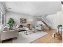 Cozy living room featuring a plush white rug, modern furniture, and an open staircase at 1170 Monroe Dr # C, Boulder, CO 80303