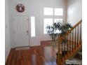 Home entry with hardwood floors, and access to stairs and living room at 12609 Jersey W Cir, Thornton, CO 80602