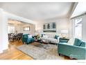 Spacious living room with hardwood floors and teal accents at 1452 Cherrywood Way, Longmont, CO 80504