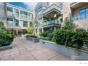 Private courtyard with lush landscaping and paved walkways at 1655 Walnut St # 309, Boulder, CO 80302