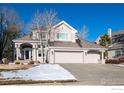 Exterior view of two story house with attached three car garage in winter at 1825 Vernon Ln, Superior, CO 80027