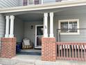 Inviting front porch with brick pillars and comfortable seating at 2010 E 99Th Pl, Thornton, CO 80229