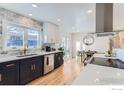 Updated kitchen featuring white and navy cabinets, quartz countertops, and a breakfast nook at 3000 Dartmouth Ave, Boulder, CO 80305