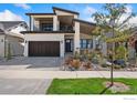 Modern two-story house with stone and white siding, dark brown garage door, and landscaped front yard at 3364 Danzante Bay Ct, Berthoud, CO 80513