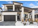 Two-story modern home with dark brown garage doors and light-colored stone exterior at 3364 Danzante Bay Ct, Berthoud, CO 80513