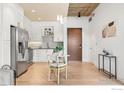 Open concept kitchen with white cabinets and a breakfast bar at 3401 Arapahoe Ave # 102, Boulder, CO 80303