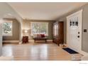 Light-filled living room with hardwood floors and an antique wardrobe at 402 11Th N Ave, Longmont, CO 80501