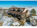 Aerial view of a house with a large yard and outbuildings at 420 E County Road 10, Berthoud, CO 80513