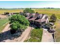 Aerial view of a ranch style home with acreage and outbuildings at 420 E County Road 10, Berthoud, CO 80513