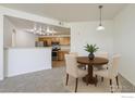 Charming dining area adjacent to the kitchen, perfect for meals and gatherings at 5756 N Genoa Way # 205, Aurora, CO 80019