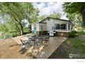 Back patio with seating area and grill, next to the house at 6903 Valmont Rd, Boulder, CO 80301