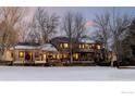 Exterior rear view of home featuring a backyard porch and large backyard at 7035 Rustic Trl, Boulder, CO 80301