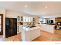 Modern kitchen with white cabinets, island, and stainless steel appliances at 710 Linden Park Dr, Boulder, CO 80304