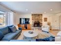 Cozy living room with stone fireplace and large TV at 710 Linden Park Dr, Boulder, CO 80304