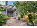 Inviting front entrance with stonework, landscaping, and a charming covered entryway at 7181 Longview Dr, Niwot, CO 80503