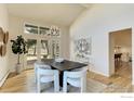 Elegant dining area with vaulted ceilings, access to the backyard, and modern chandelier at 7332 Island Cir, Boulder, CO 80301