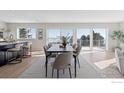 Modern dining room with large windows offering scenic views and access to deck at 8393 Stoneridge Ter, Boulder, CO 80302