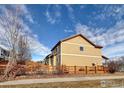 Tan house with wooden fence and backyard at 9821 Mobile St, Commerce City, CO 80022