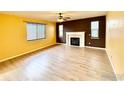 Living room with fireplace and laminate floors at 9821 Mobile St, Commerce City, CO 80022