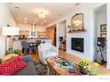 Open concept living room with fireplace and kitchen at 105 N Iowa Ave, Lafayette, CO 80026